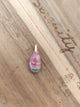 Pendentif rhodochrosite brute posé sur bois